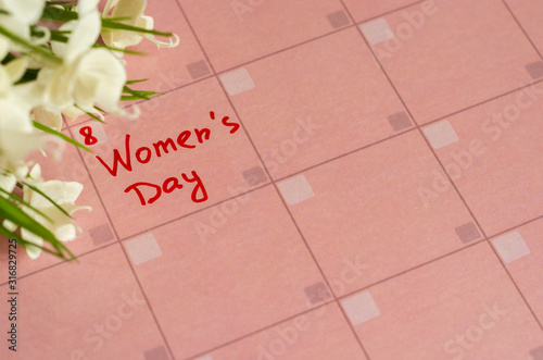 Inscription Happy Women's Day in pink calendar