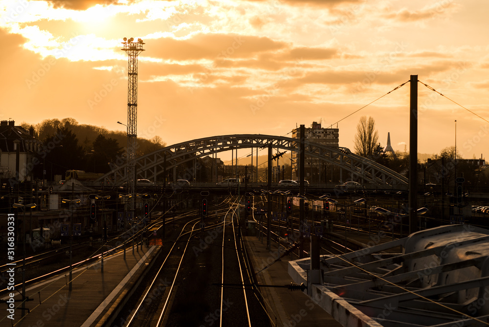 Φωτογραφία View of cityscape of Mulhouse in France with  railways and bridge silhouette by