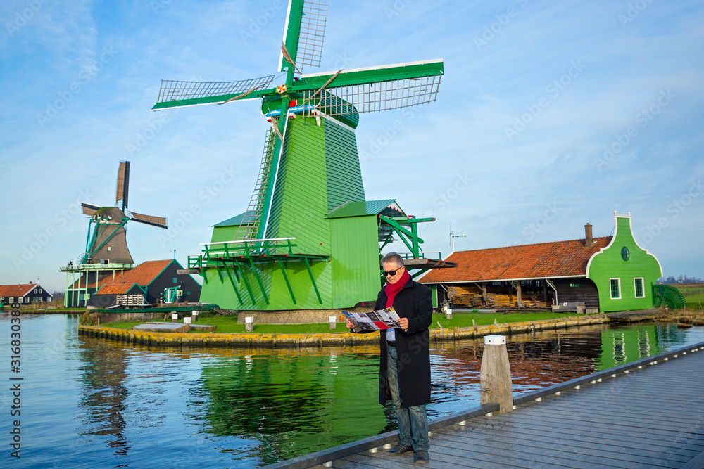Man with a map walks  in Zaanse Schans