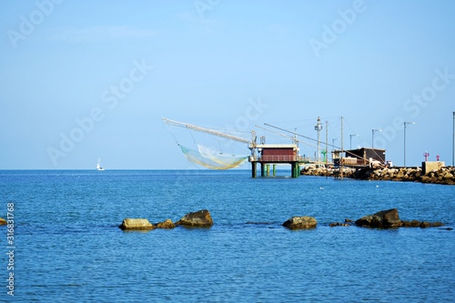 caratteristiche capanne da pesca sul molo di Porto Garibaldi nel Mare Adriatico nel comune di Comacchio in provincia di Ferrara in Italia photo