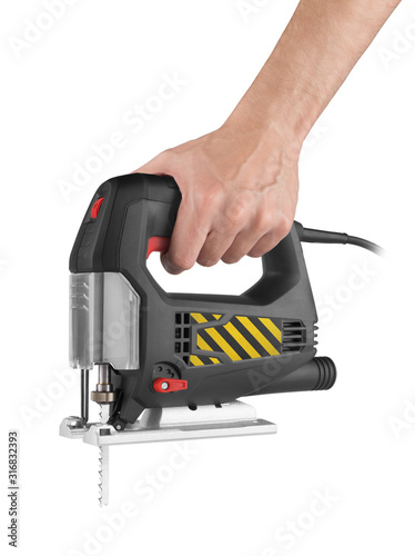 Hand holds electric jig saw isolated photo