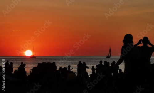 silhouette of people on the beach at sunset © luciarochaw