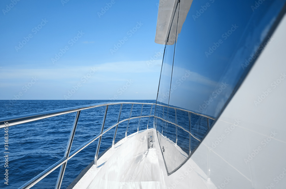 Fototapeta premium Modern boat side and railing on a sunny day, luxury travel concept.