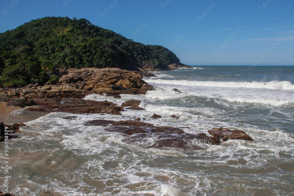 the famous paradise beach with stones, rocks and lush tropical vegetation of Trindade in the Paraty area. 