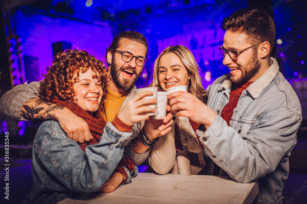 Friends drinking hot wine and having fun on outdoor concert. Celebrating new year Friends drinking hot wine and having fun on outdoor concert. Celebrating new year