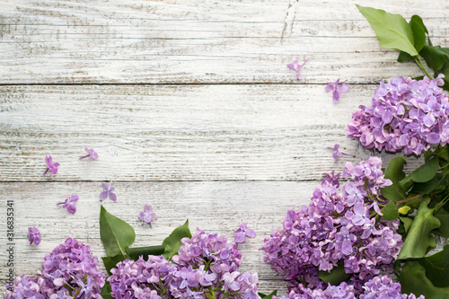 blooming spring lilac flowers on a white wooden background