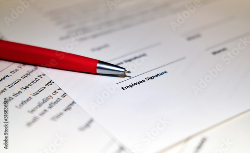 Contract sheet with a pen on a wooden background