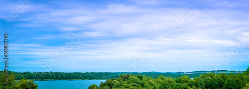 Panoramic top view of the lake with cloudy sky after sunset. © KielaRob