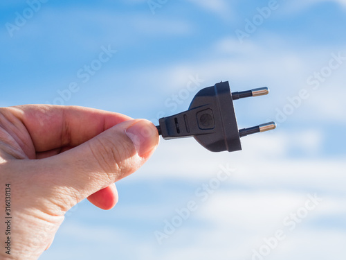 Man holding a black plug