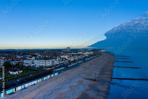 Bognor Regis aerial view looking towards pier and town centre with dramatic cloud over the sea and clear calm conditions over the town.