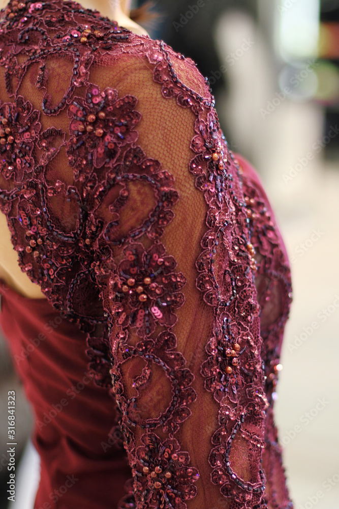 Haute couture fashion detail. Beautiful luxury red dress, close up.  Embroidered sleeves on evening dress. Stock Photo | Adobe Stock