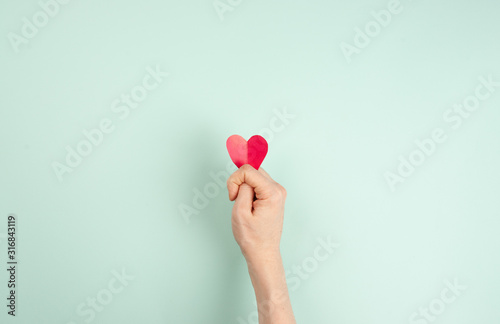 red heart in the hand instead of figs, a symbol of unrequited love, infidelity, divorce