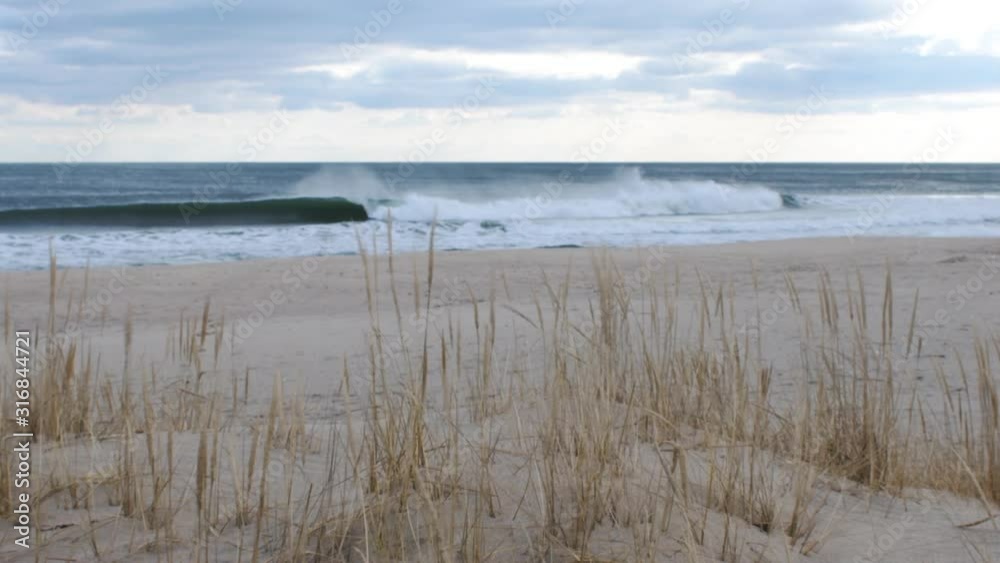 Rough seas and waves breaking on beach on Jersey shore Rough seas and waves breaking on beach on Jersey shore