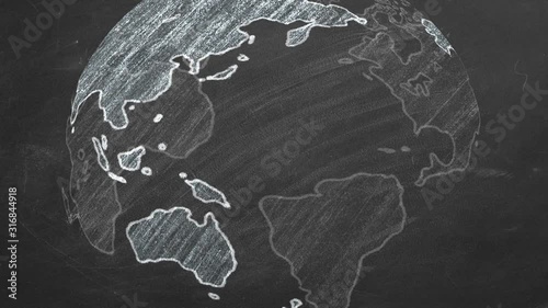 Rotating globe hand drawn in chalk on a school blackboard.