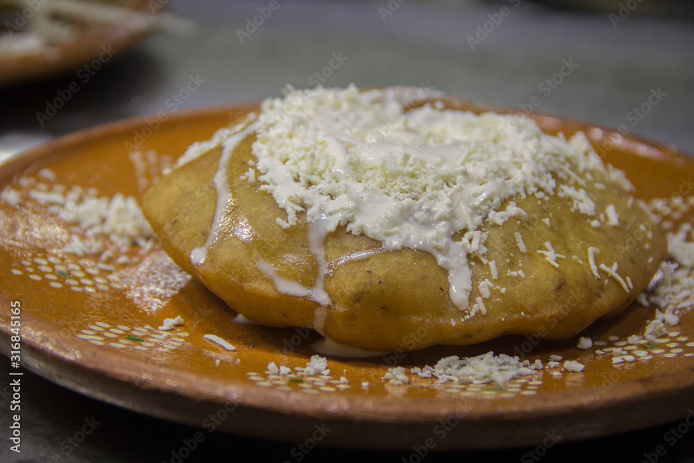 Fried mexican snack and fresh crumbled cheese Fried mexican snack and fresh crumbled cheese
