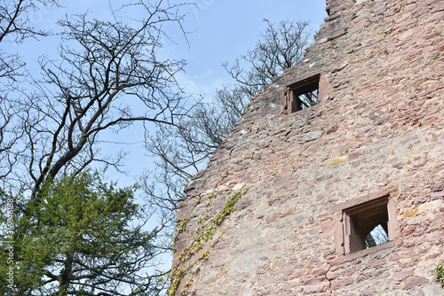 Stone wall ruins of an old castle of Schloss Neuenburg in Germany, against a blue sky with text space photo
