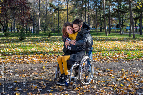 Disabled young woman with boyfriend in the park