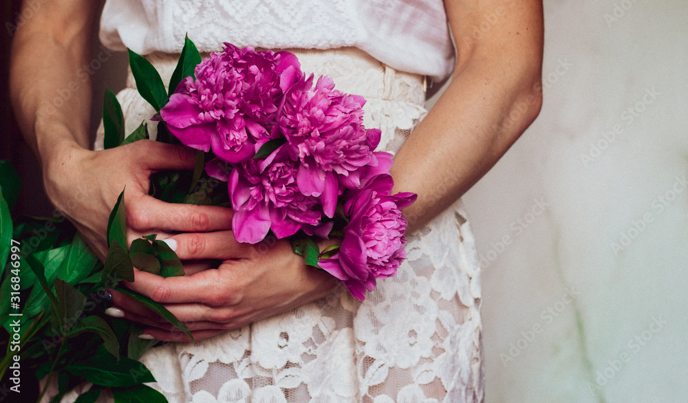 woman holding beautiful bouque of peonies, close up woman holding beautiful bouque of peonies, close up