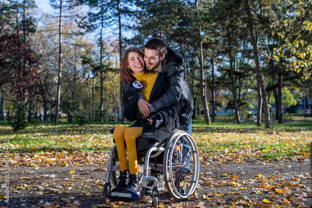 Disabled young woman with boyfriend in the park Disabled young woman with boyfriend in the park