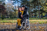 Disabled young woman with boyfriend in the park