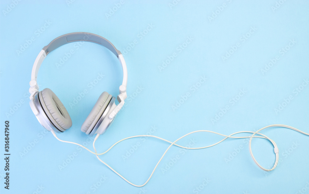 Headphones on blue pastel background Headphones on blue pastel background