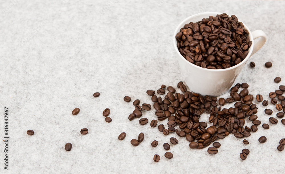 Good coffee beans in a caffe mug Good coffee beans in a caffe mug