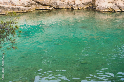 Beautiful landscape with turquoise water surface and rocky cliffs in Calanques National Park.
