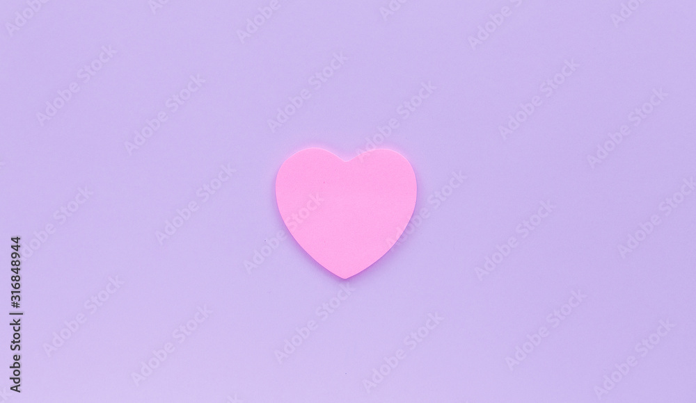 Paper pink heart on a purple background