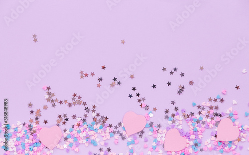 A lot of hearts and stars on a purple background.