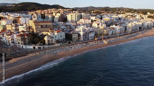 Aerial view of train passing throug Sant Pol de Mar in el Maresme coast, Catalonia, Spain. photo