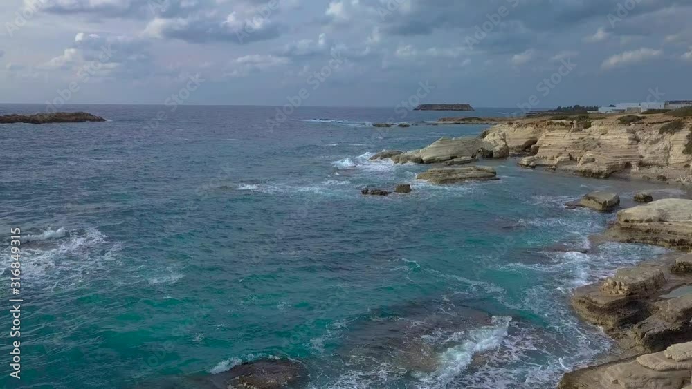 Flight over the Mediterranean coast. Waves crash on beautiful white rocks. 4K Flight over the Mediterranean coast. Waves crash on beautiful white rocks. 4K