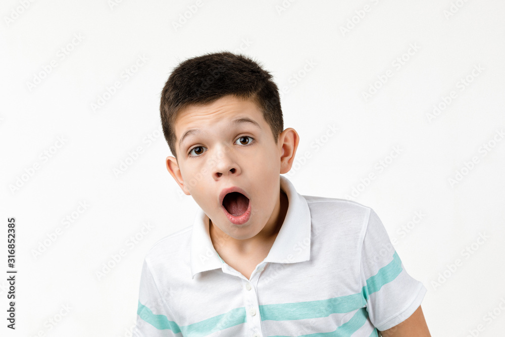 surprised little child boy in t-shirt looking to camera on white background. Human emotions and facial expression surprised little child boy in t-shirt looking to camera on white background. Human emotions and facial expression