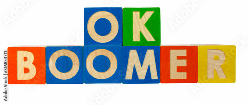 OK BOOMER spelled out with colorful toy block. OK BOOMER is a catchphrase used to dismiss or mock attitudes stereotypically attributed to the baby boomer generation. photo