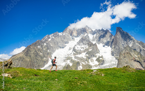 A trail runner running in the high mountains of the Alps