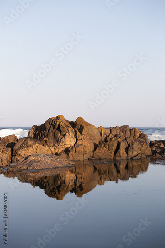 Rocky beach with still water pool