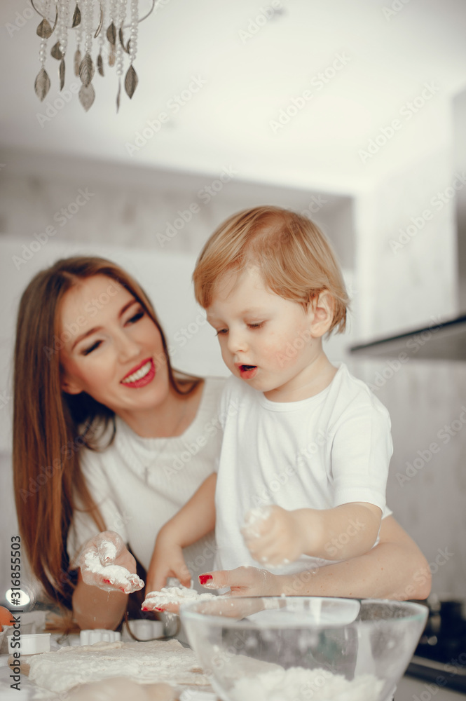 Fototapeta premium Family in a kitchen. Beautiful mother with little son