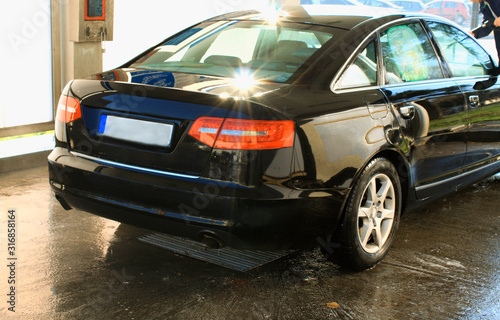 car washing cleaning with hi pressured water and shine after