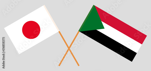 Crossed flags of Sudan and Japan