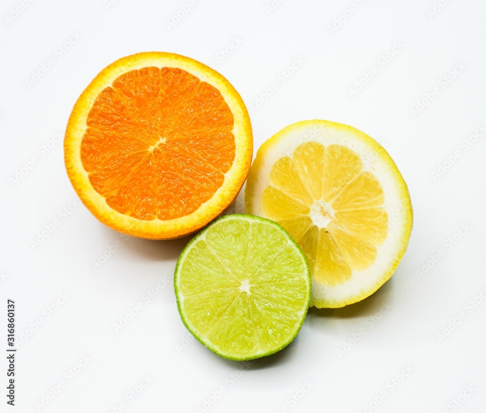 cut piece of an orange, lemon and lime on a white background cut piece of an orange, lemon and lime on a white background