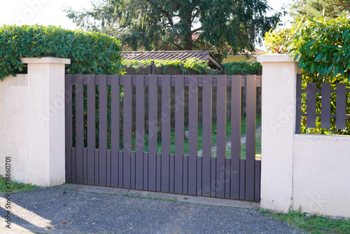 Metal driveway entrance gates house garage in suburb