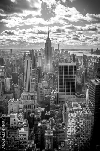 New York  United States     January 5  2020  Top of the Rock in New York  the Empire State Building surrounded by skyscrapers. Black and white photo