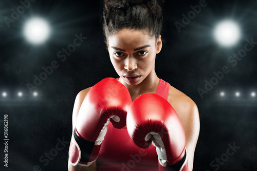 Confident black woman boxer standing in pose, ready to fight © Prostock-studio