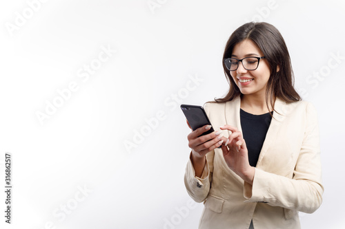 Cheerful female white collar in glasses using smartphone isolated white background copyspace