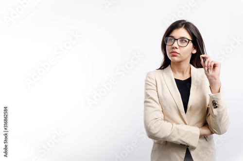 Pretty thoughtful female office clerk in glasses looking upwards isolated white background copyspace