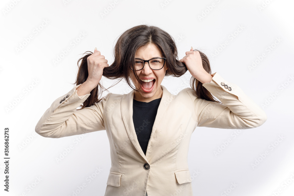 Stressed female office clerk in glasses screaming and pulling her hair isolated white background Stressed female office clerk in glasses screaming and pulling her hair isolated white background