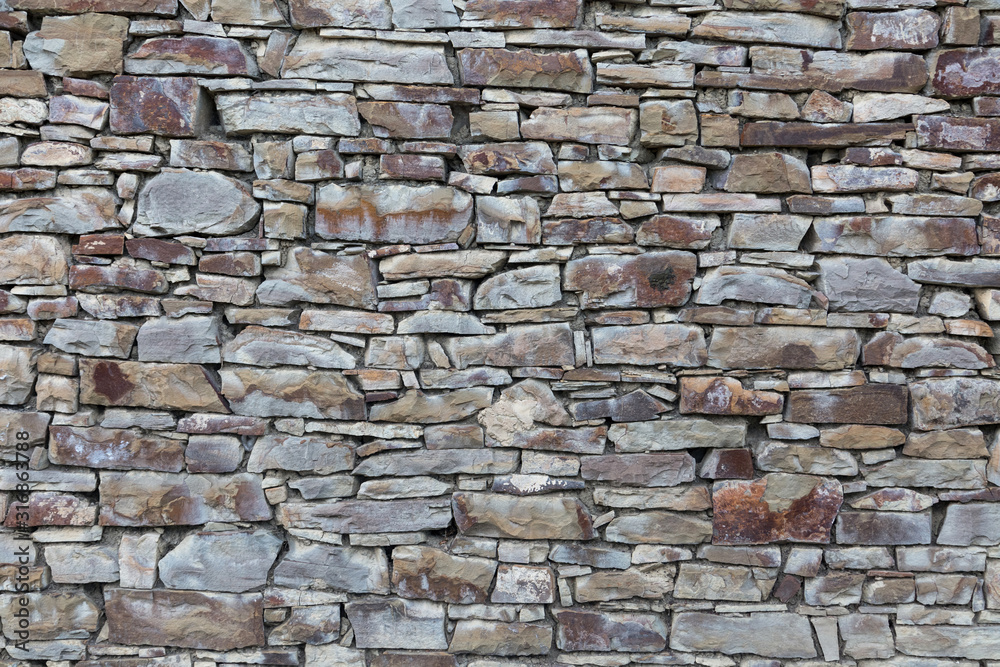 Obraz premium Background, texture. The wall is made of wild natural stone, gray.