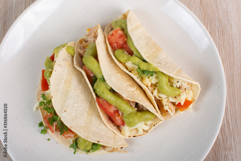 Mexican tacos with chicken, vegetables and guacamole Mexican tacos with chicken, vegetables and guacamole