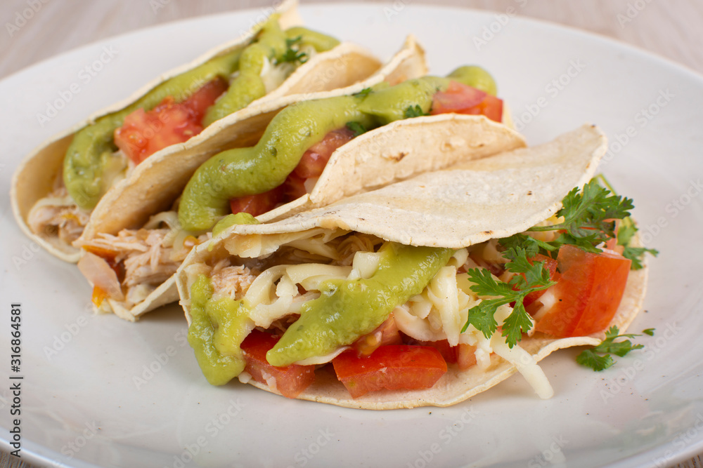 Mexican tacos with chicken, vegetables and guacamole Mexican tacos with chicken, vegetables and guacamole