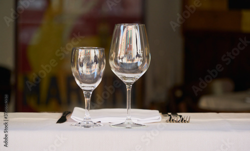 cutlery and wine glasses prepared for use in a restaurant. front image