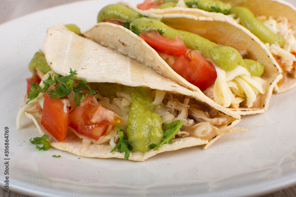 Mexican tacos with chicken, vegetables and guacamole Mexican tacos with chicken, vegetables and guacamole